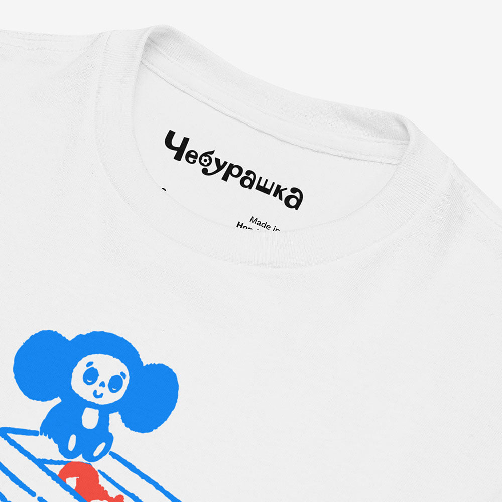 Youth white Cheburashka T-shirt with cartoon print of Cheburashka on box of oranges with Japanese チェブラーシカ logo.