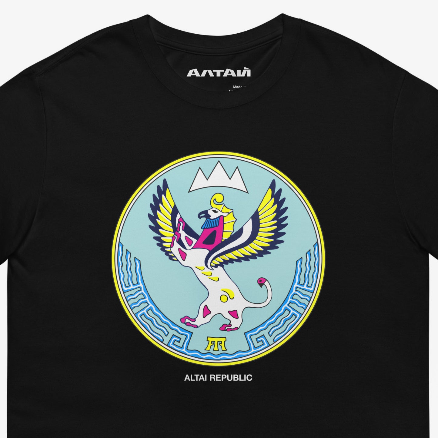 Black unisex T-shirt featuring the Altai Republic coat of arms, a unique emblem design with Russian and Soviet design influences. Featuring АЛТАЙ text logo on necktag. Closeup photo. www.artsoviet.com
