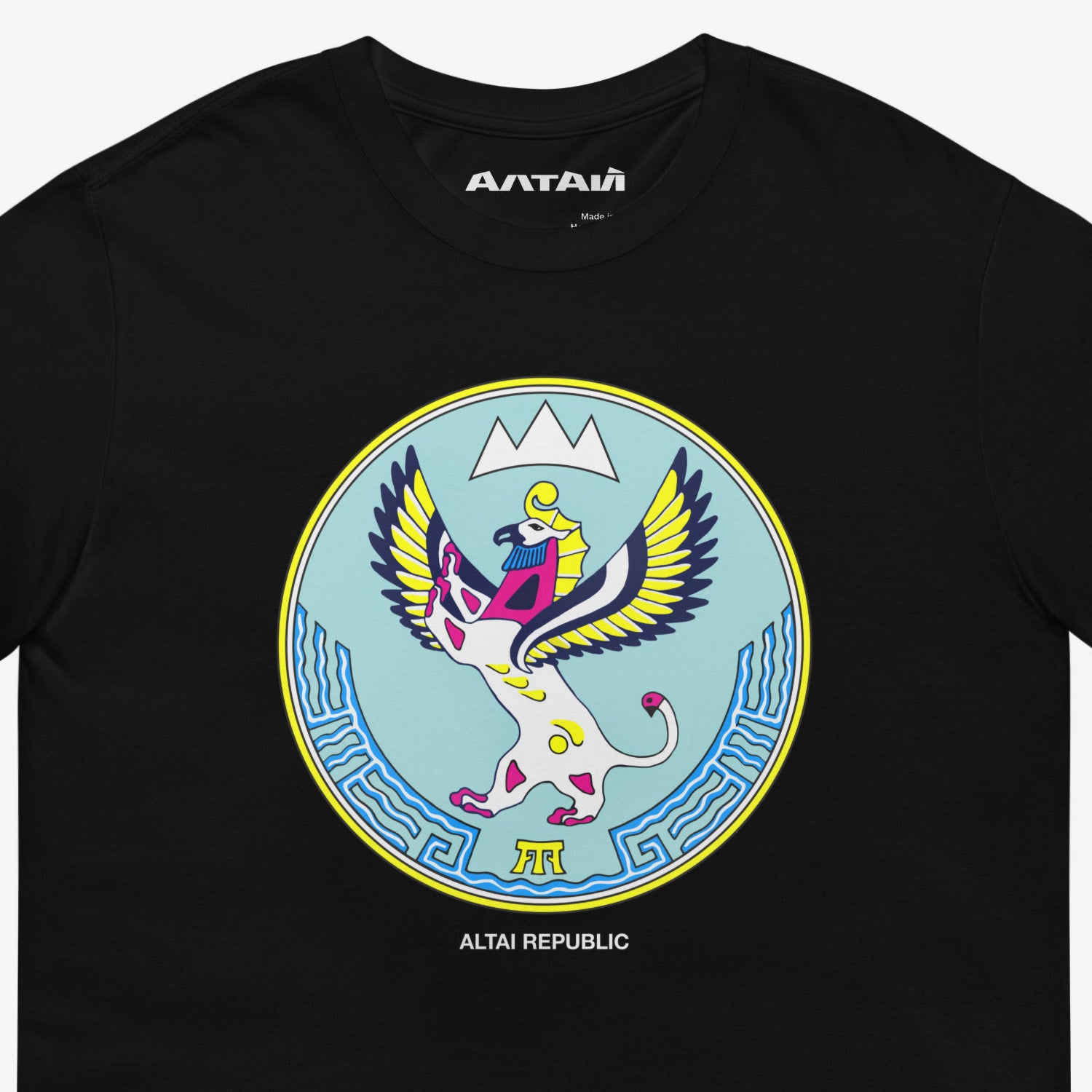 Black unisex T-shirt featuring the Altai Republic coat of arms, a unique emblem design with Russian and Soviet design influences. Featuring АЛТАЙ text logo on necktag. Closeup photo. www.artsoviet.com