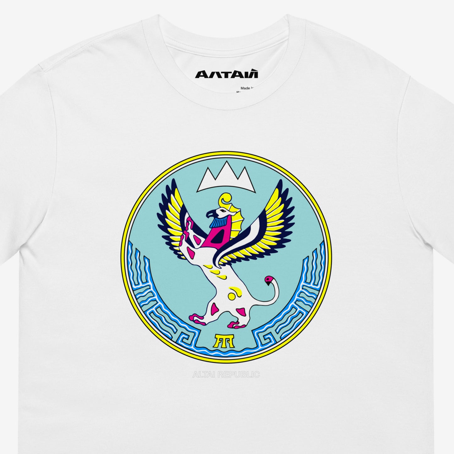 White unisex T-shirt featuring the Altai Republic coat of arms, a unique emblem design with Russian and Soviet design influences. Featuring АЛТАЙ text logo on necktag. Closeup photo. www.artsoviet.com