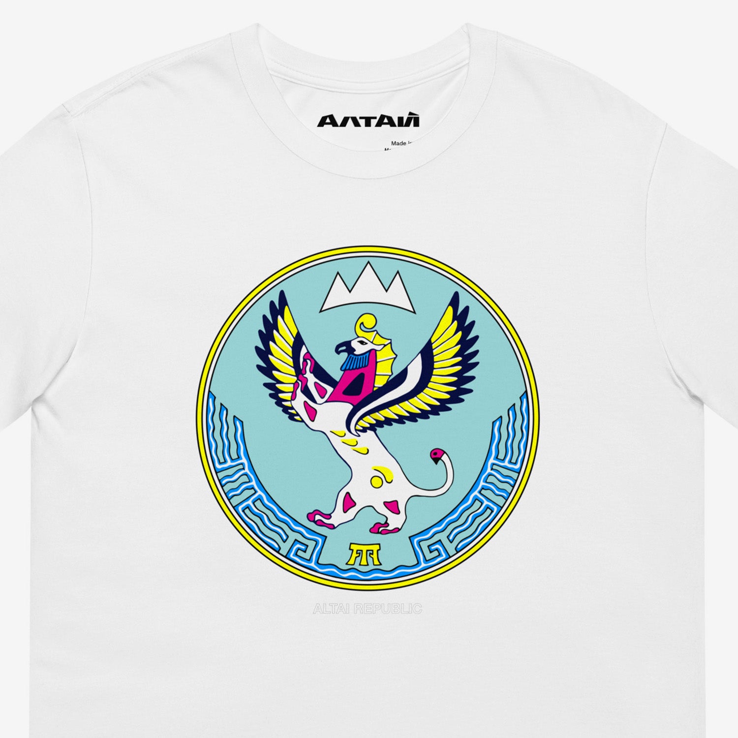 White unisex T-shirt featuring the Altai Republic coat of arms, a unique emblem design with Russian and Soviet design influences. Featuring АЛТАЙ text logo on necktag. Closeup photo. www.artsoviet.com