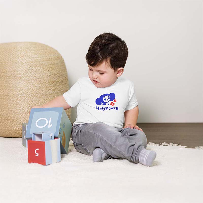 Baby boy wearing T-shirt featuring an exclusive Cheburashka design with flowers. Soft, high-quality fabric, perfect for birthdays and gifts. Unique Soviet nostalgia merch, available only at Soviet Visual.