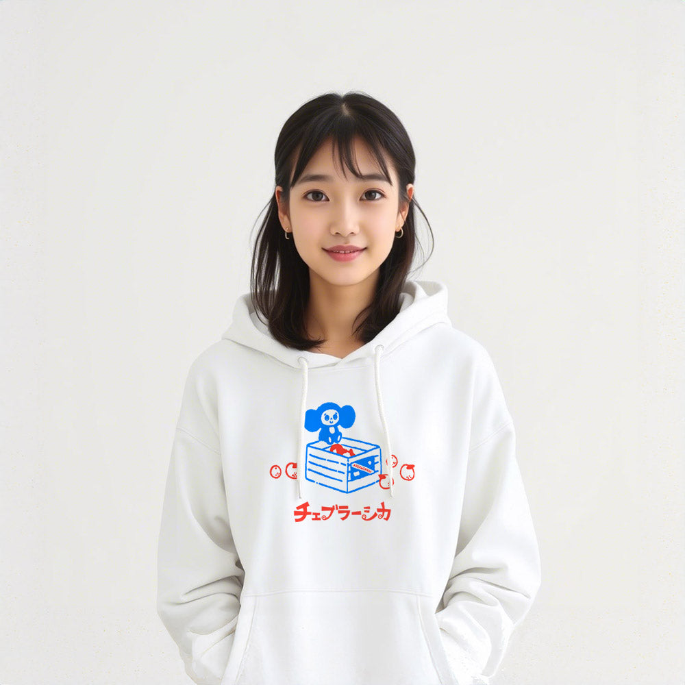 Cute japanese girl wearing white unisex hoodie with a print of Soviet cartoon Cheburashka on a box of oranges with チェブラーシカ text in Japanese.