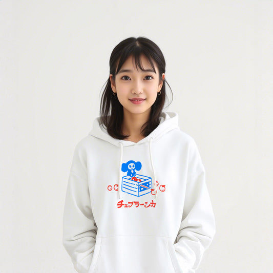Cute japanese girl wearing white unisex hoodie with a print of Soviet cartoon Cheburashka on a box of oranges with チェブラーシカ text in Japanese.