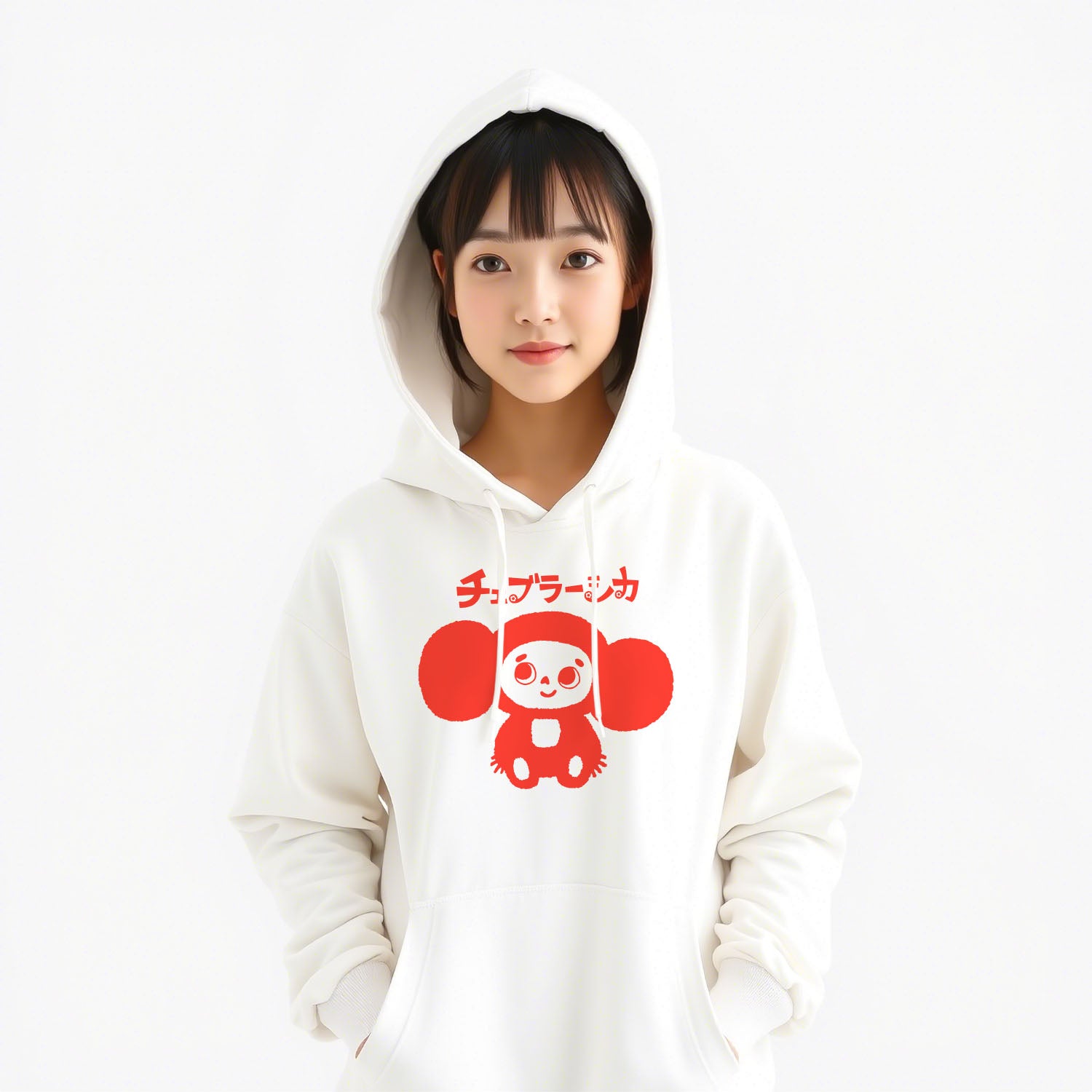 Cute japanese girl wearing white unisex hoodie with a print of Cheburashka smiling and チェブラーシカ text in Japanese.