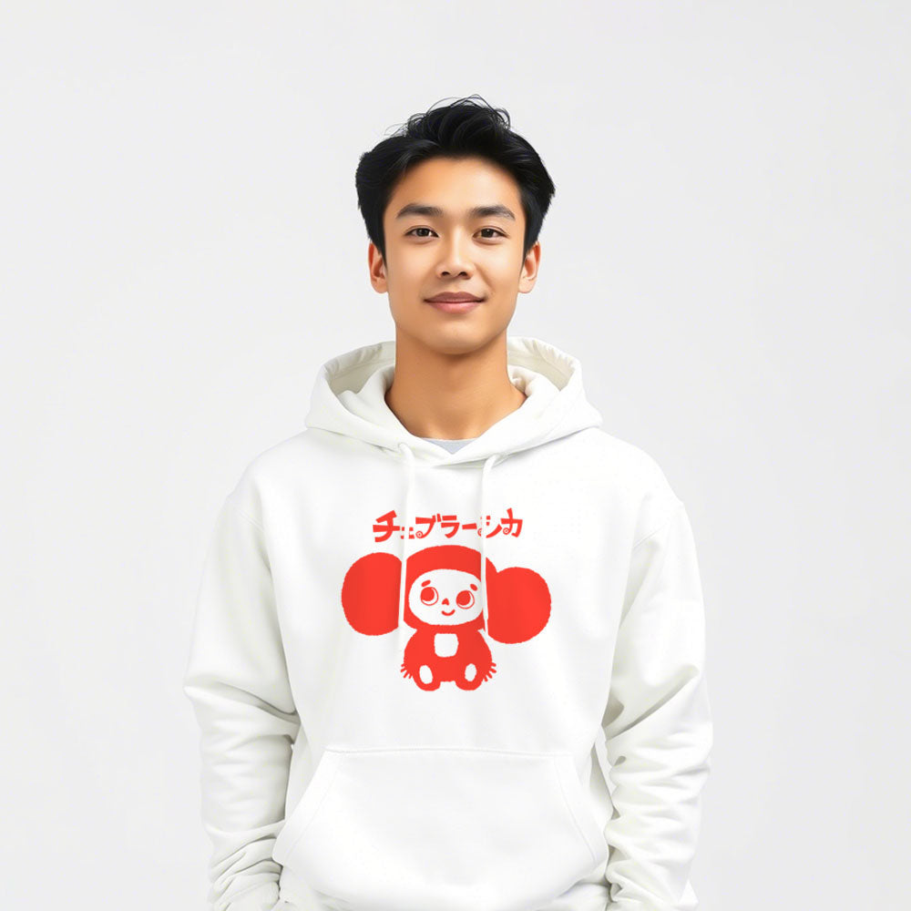 Cool japanese boy wearing white unisex hoodie with a print of Cheburashka smiling and チェブラーシカ text in Japanese.