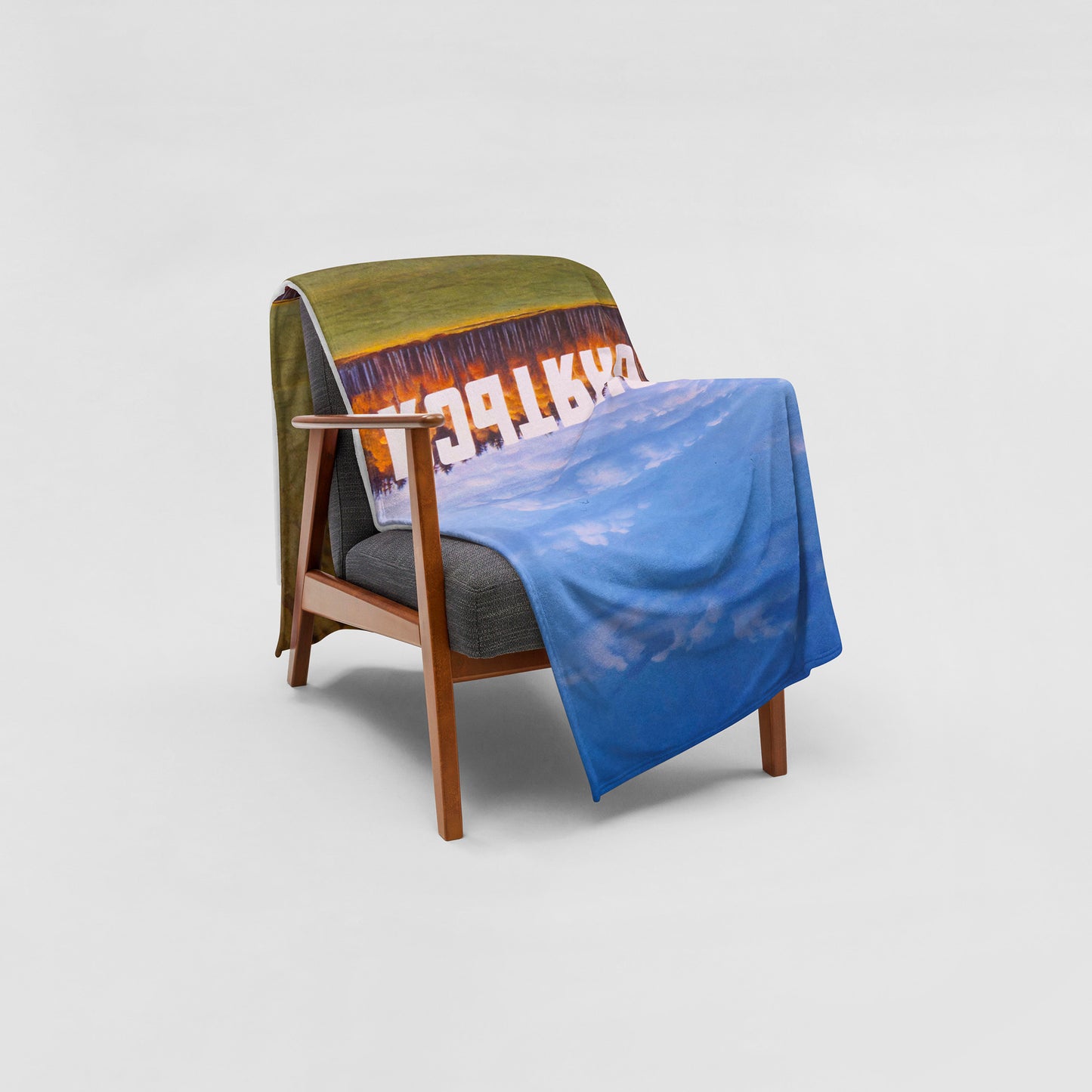 Large blanket with Erik Bulatov painting 'Do not lean depicting white text 'Не прислоняться' over an autumn birch forest. Lying on armchair. www.artsoviet.comw