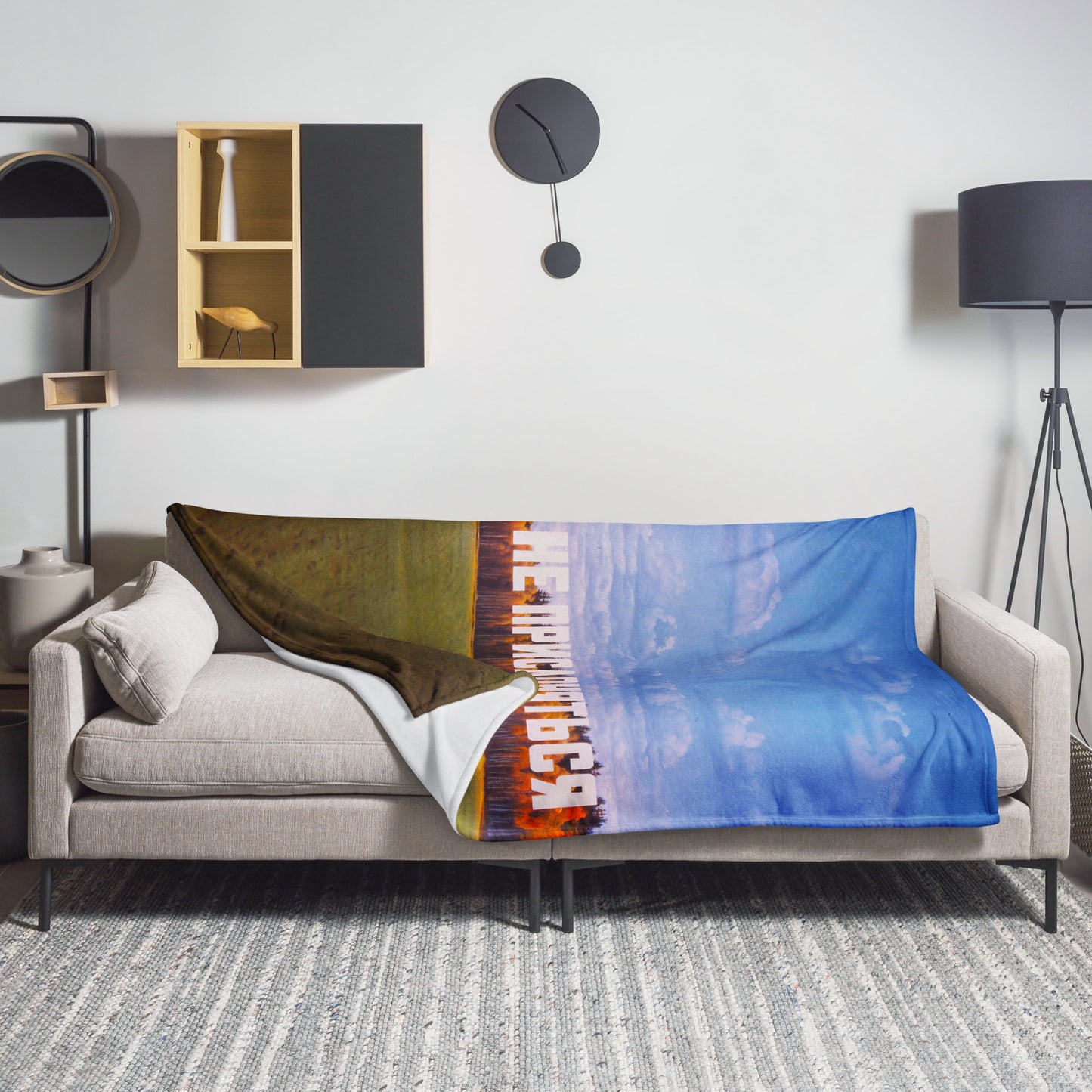 Large blanket with Erik Bulatov painting 'Do not lean depicting white text 'Не прислоняться' over an autumn birch forest. Lying on sofa. www.artsoviet.comw