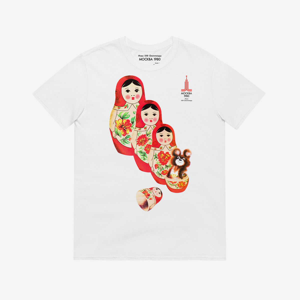 White unisex vintage T-shirt featuring Moscow 1980 Soviet mascot bear Misha and Matryoshka dolls. Official vintage USSR sport games promotion art
