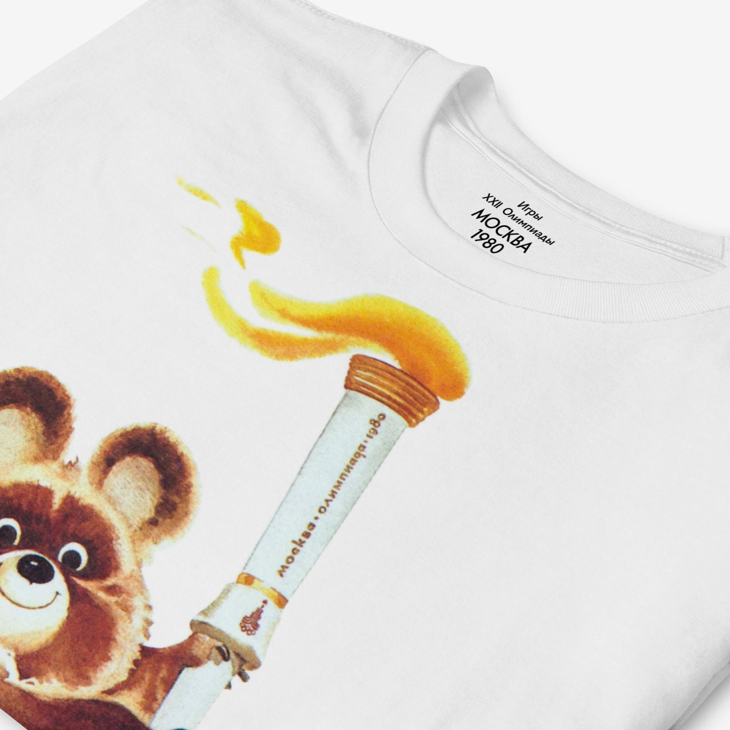 Misha the Olympic Bear T-shirt featuring the iconic 1980 Moscow Olympics design with the Olympic torch, celebrating Soviet sports history. Closeup photo. www.artsoviet.com