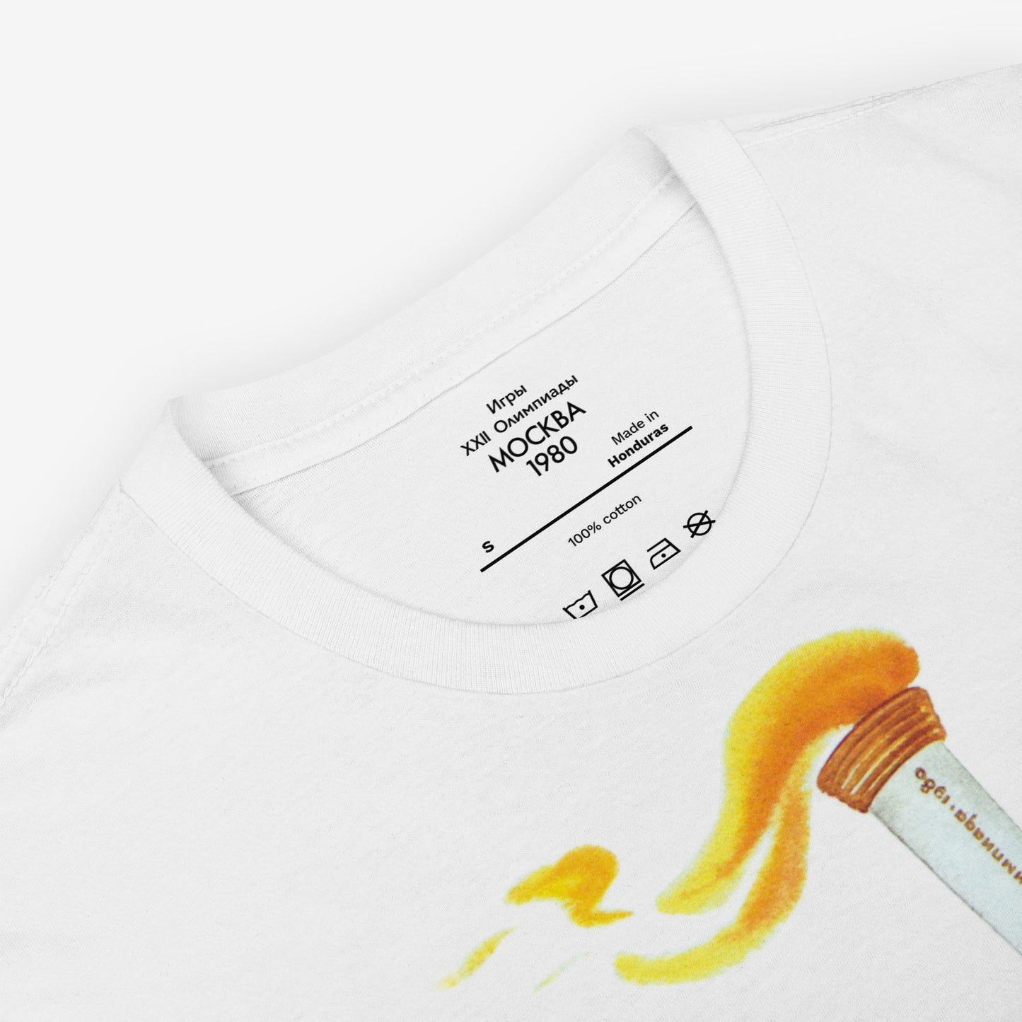Misha the Olympic Bear T-shirt featuring the iconic 1980 Moscow Olympics design with the Olympic torch, celebrating Soviet sports history. Closeup photo with branded olympic necktag. www.artsoviet.com