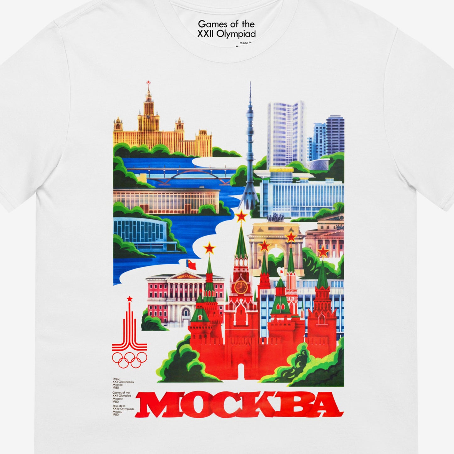 Unisex white T-shirt with large vintage print of Moscow 1980 Olympic Games art featuring Kremlin, Ostankino Tower, and Moscow landmarks. Closeup photo with games of the XXII Olympiad logo seen on the necktag. www.artsoviet.com