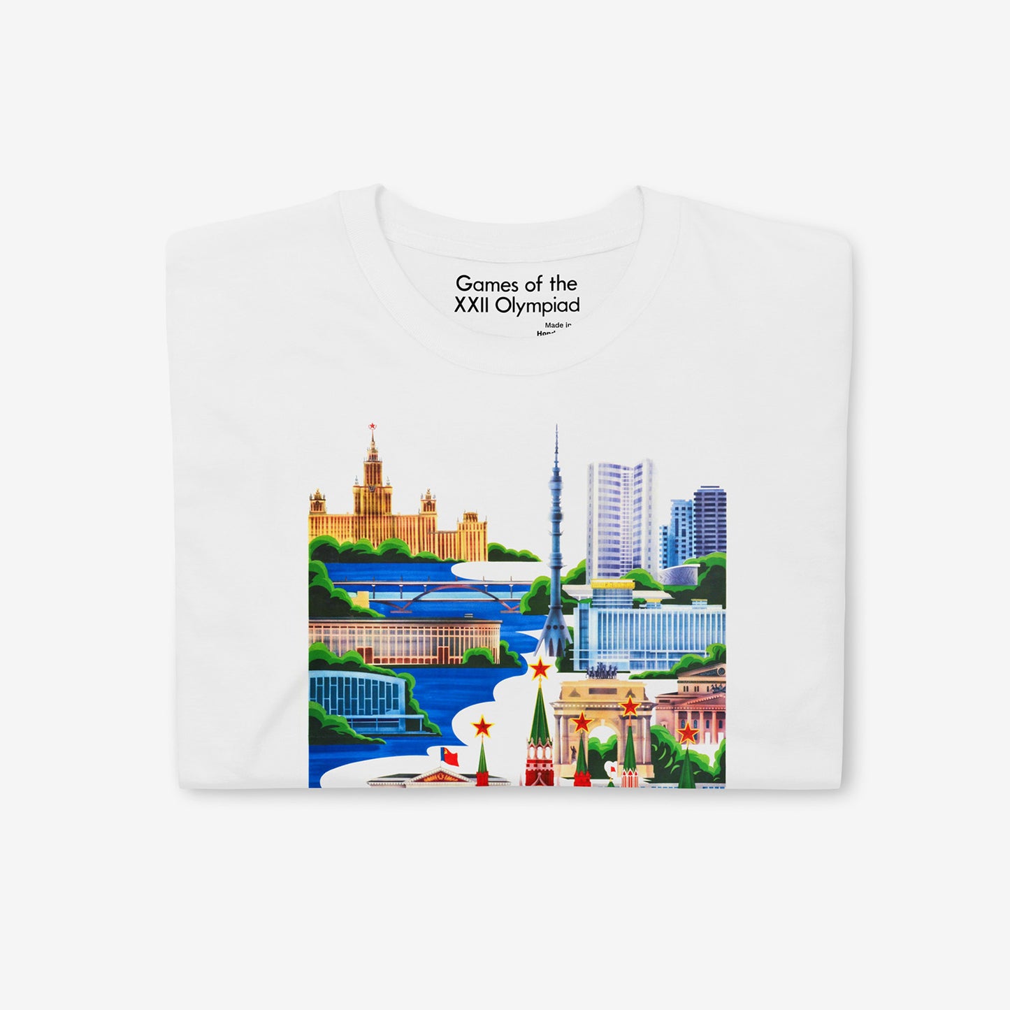 Unisex white T-shirt with Moscow 1980 Olympic Games art featuring Kremlin, Ostankino Tower, and Moscow landmarks. Closeup photo also showing custom necktag design with text "Games of the XXII Olympiad". www.sovisual.art