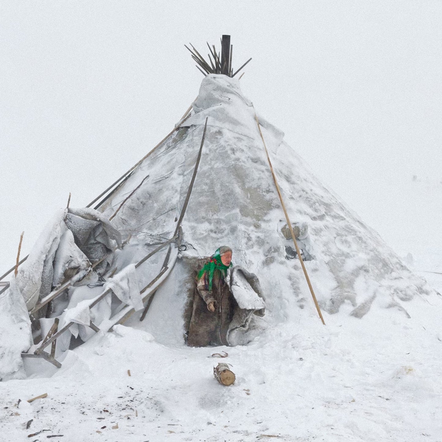 Photo of Nenets woman in traditional clothing near chum tent house in Arctic snow. Closeup photo. Siberian indigenous poster. From artsoviet.com