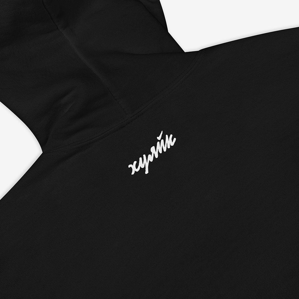 Funny Russian ХУЯЙК parody logo design in bold Cyrillic lettering on premium unisex hoodie – a play on Nike with Russian Gopnik slang twist, perfect for expats and streetwear lovers