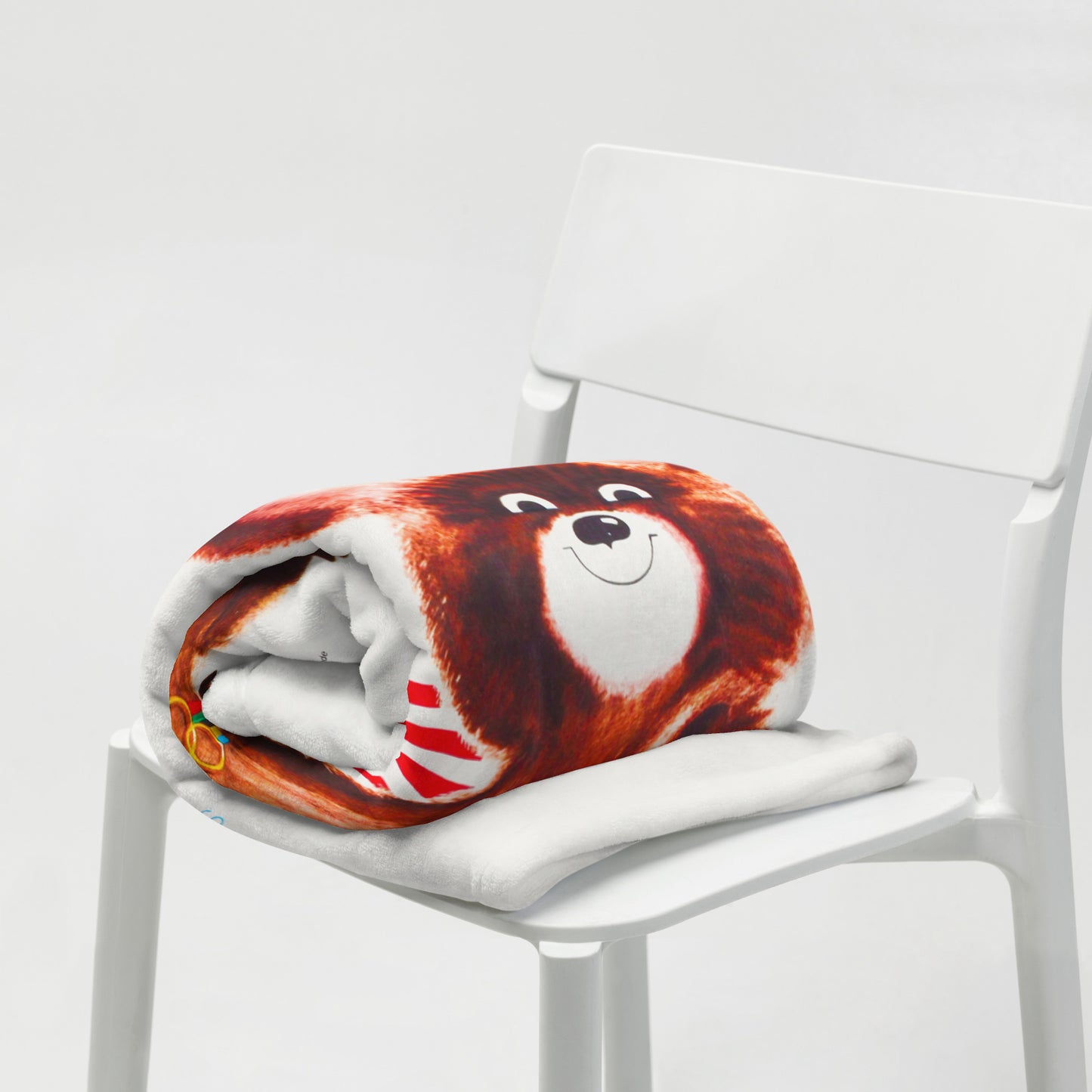 Large white blanket with Soviet Olympic Bear Misha and Moscow 1980 Olympic Games logo - folded on the chair