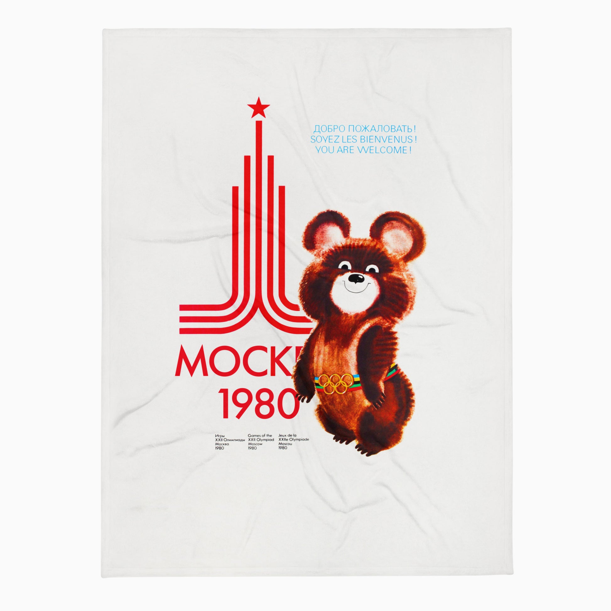 Large white blanket with Soviet Olympic Bear Misha and Moscow 1980 Olympic Games logo and text Welcome in French, Russian and english