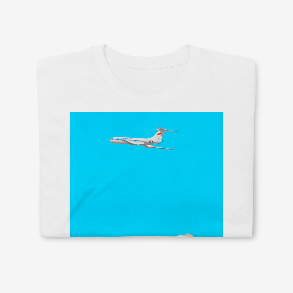 Unisex T-shirt featuring dreamy Soviet blonde boy watching Aeroflot plane with red USSR flag on tail in sky, Olympic logo on back of boy's shirt