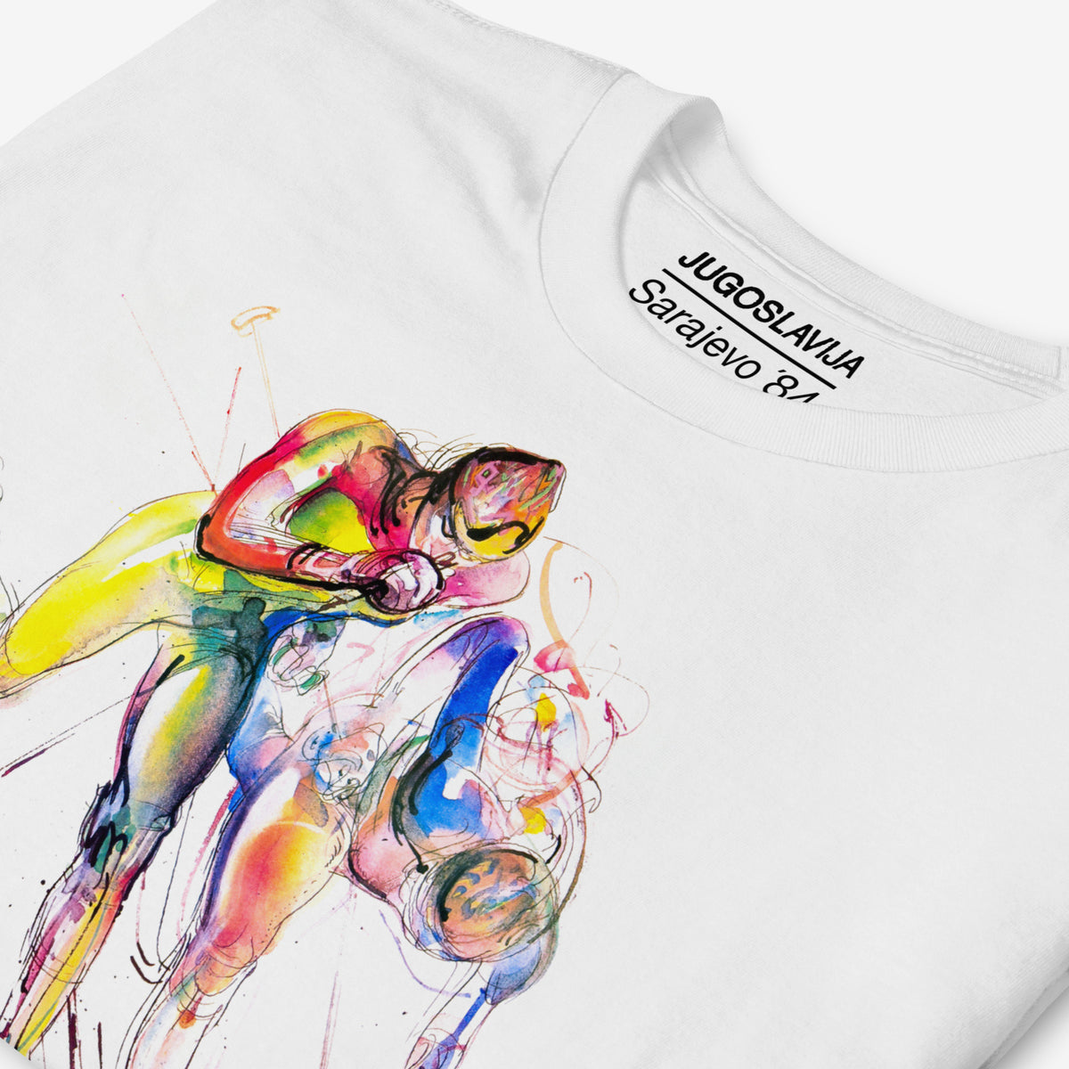 White unisex T-shirt featuring large artwork of Sarajevo 1984 Yugoslavian Winter Olympics Skiing artwork by Ismar Mujezinović. Closeup