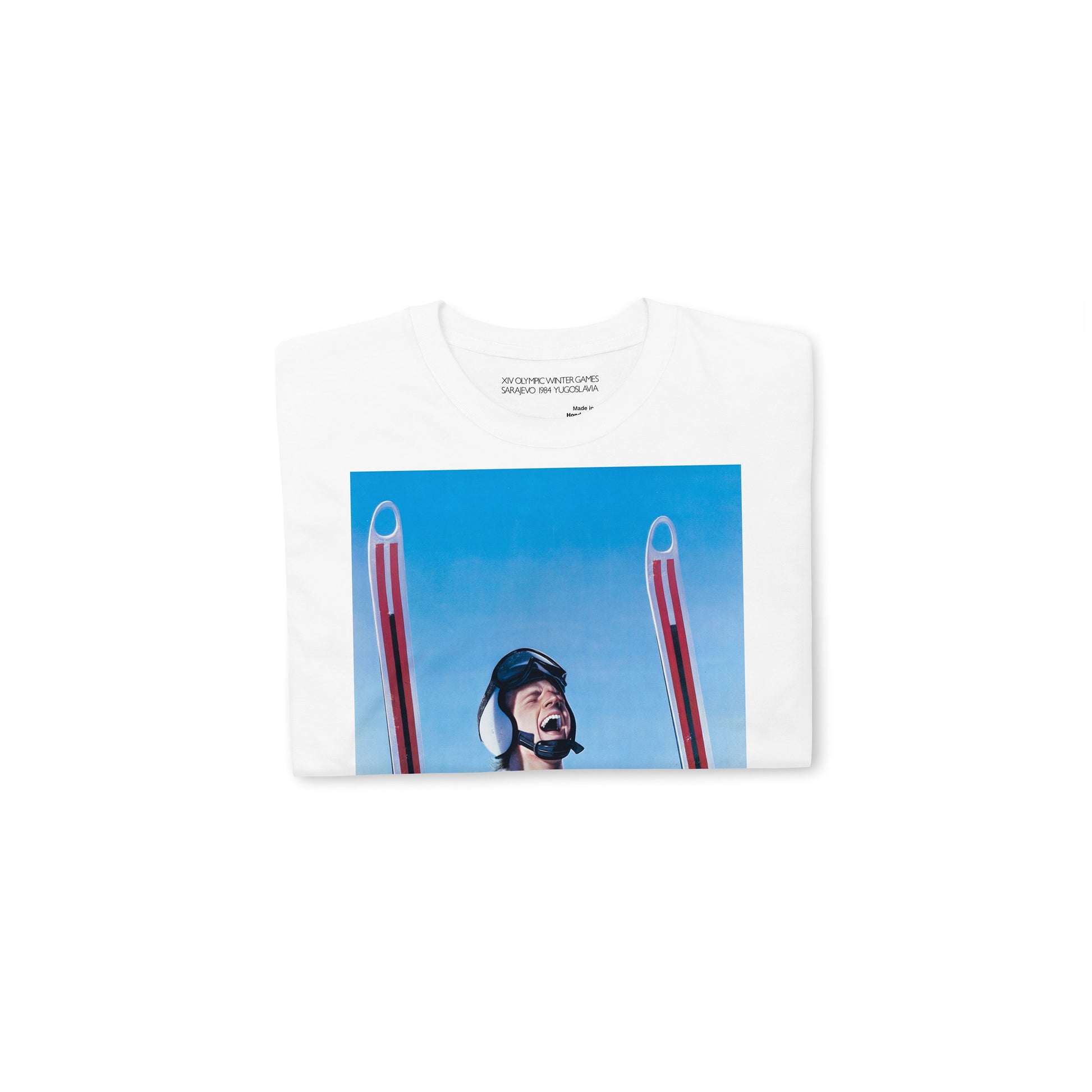 Yugoslavia Olympic Games white unisex T-shirt featuring large print of Sarajevo 1984 Winter Olympics skier. Folded. www.artsoviet.com
