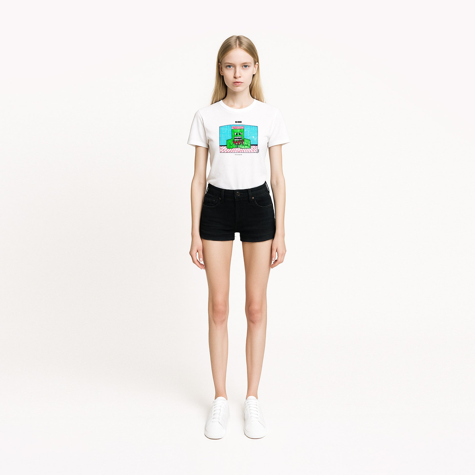 Model girl wearing rare 1980s Viktor Tsoi painting with a green man holding red human figures, printed on the front of a heavyweight unisex t-shirt with a KINO logo and original inside neck label design, from GruppaKino.com.
