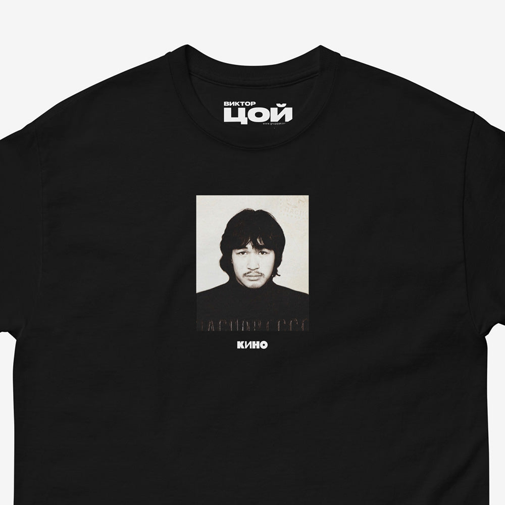 Rare Viktor Tsoi passport photo with a small KINO band logo underneath it, on the front of a heavyweight black unisex t-shirt. Closeup photo.