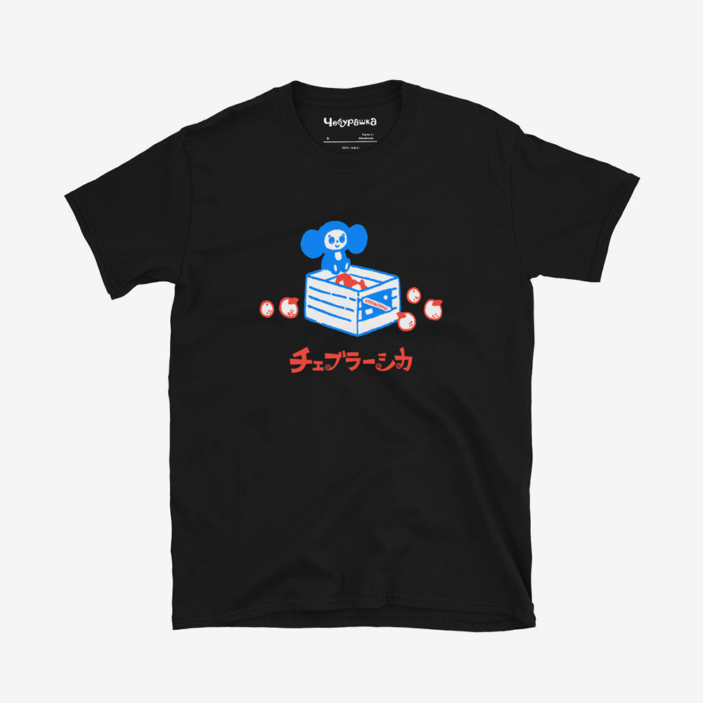 Unisex Cheburashka T-shirt with a cartoon print of Cheburashka sitting on a box of oranges and チェブラーシカ logo in Japanese.