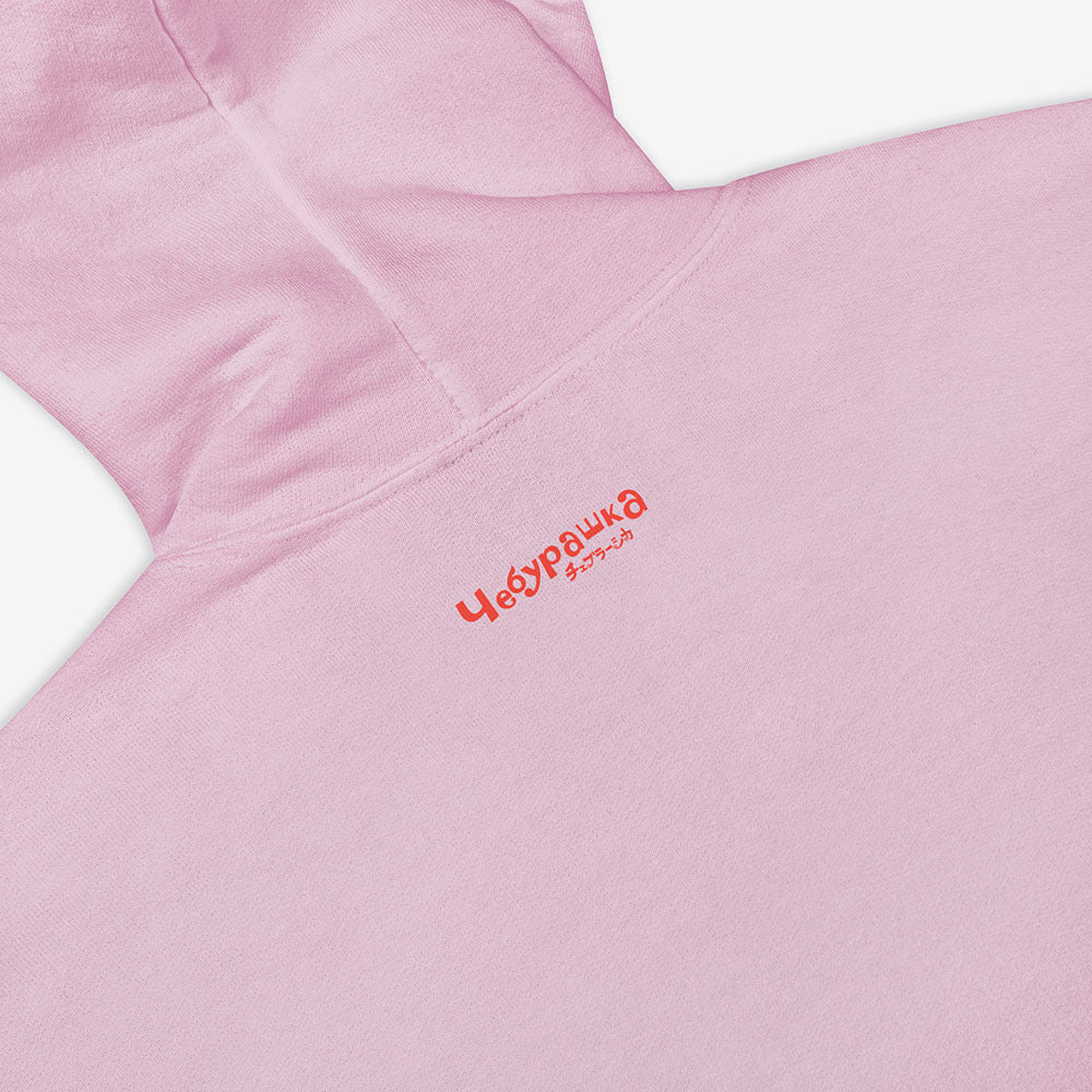 Unisex hoodie with a print of Cheburashka smiling and チェブラーシカ text in Japanese.