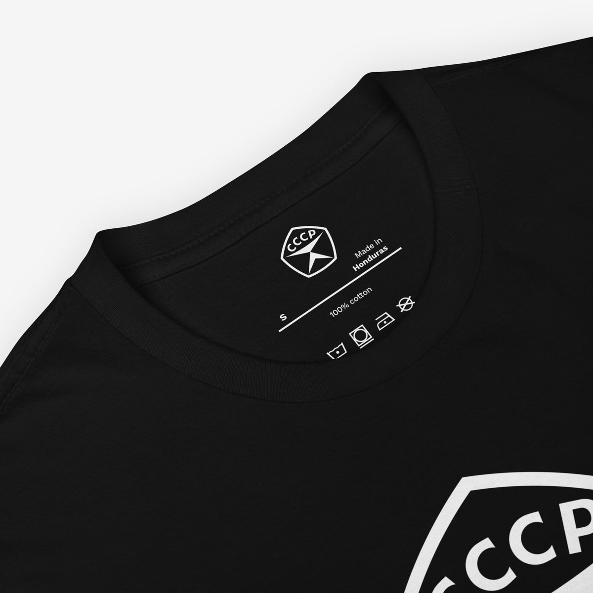 Black unisex T-shirt featuring large white USSR quality mark emblem logo 'СССР' (CCCP). Closeup