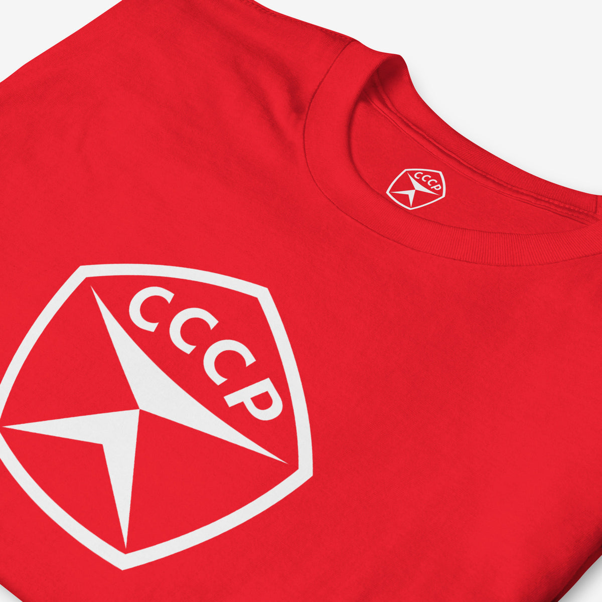 Red unisex T-shirt featuring large white USSR quality mark emblem logo 'СССР' (CCCP). Closeup