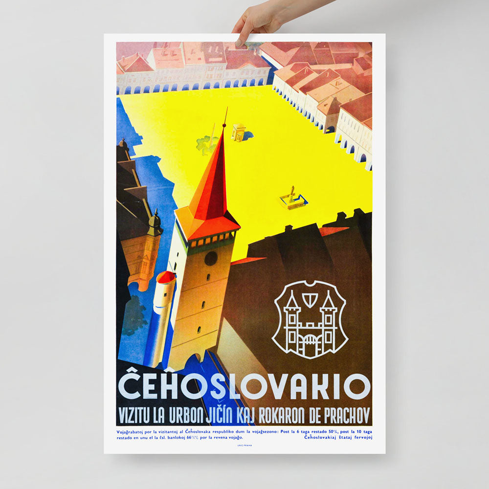A hand holding 1930s Czechoslovakia travel poster by Ladislav Horak showing Jicin Valdicka Brana gate tower and square in Art Deco style. 