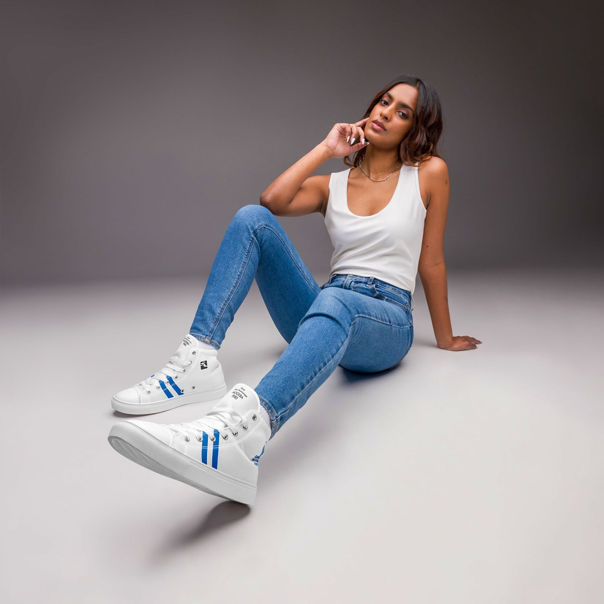 Womens Moscow 1980 Olympic Games high-top shoes with vintage navy graphics on white canvas, featuring the Olympic emblem and retro stripes.